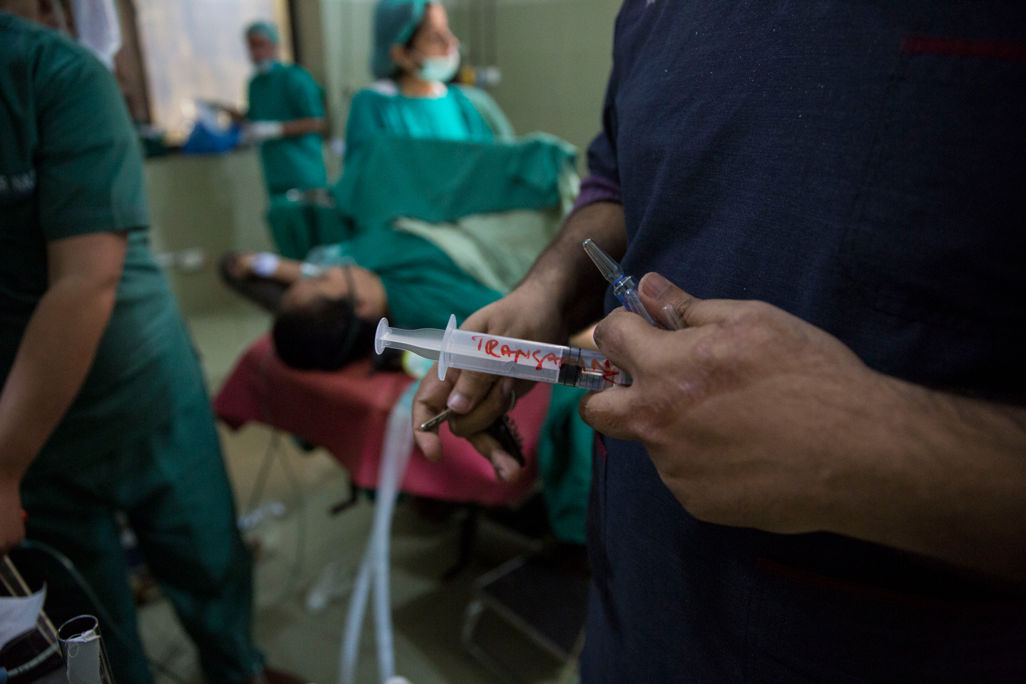 An operating theatre assistant holds a dose of tranexamic acid before the C-section begins as they are anticipating severe haemorrhaging. Holy Family Hospital, Rawalpindi. Saiyna Bashir © Wellcome Trust