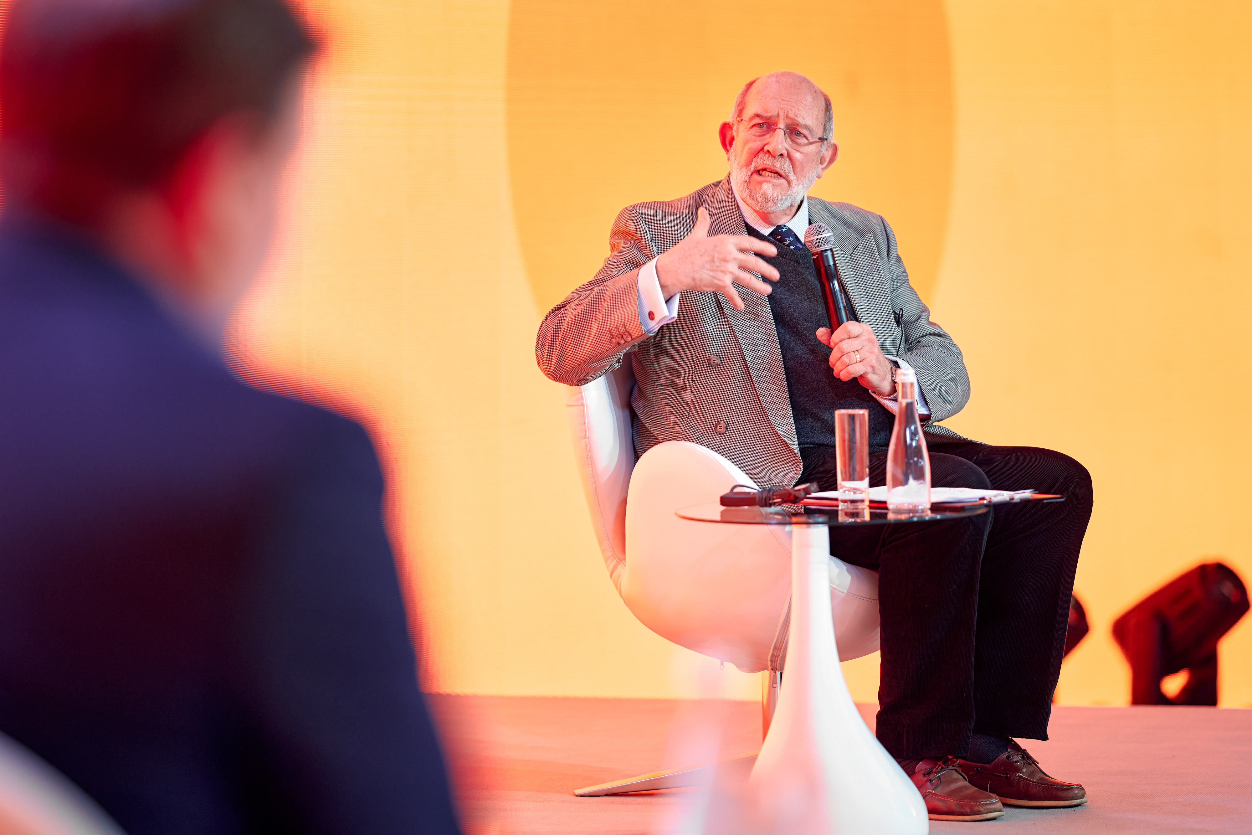 Professor Don Bundy speaks on a stage at the European School Meals Summit