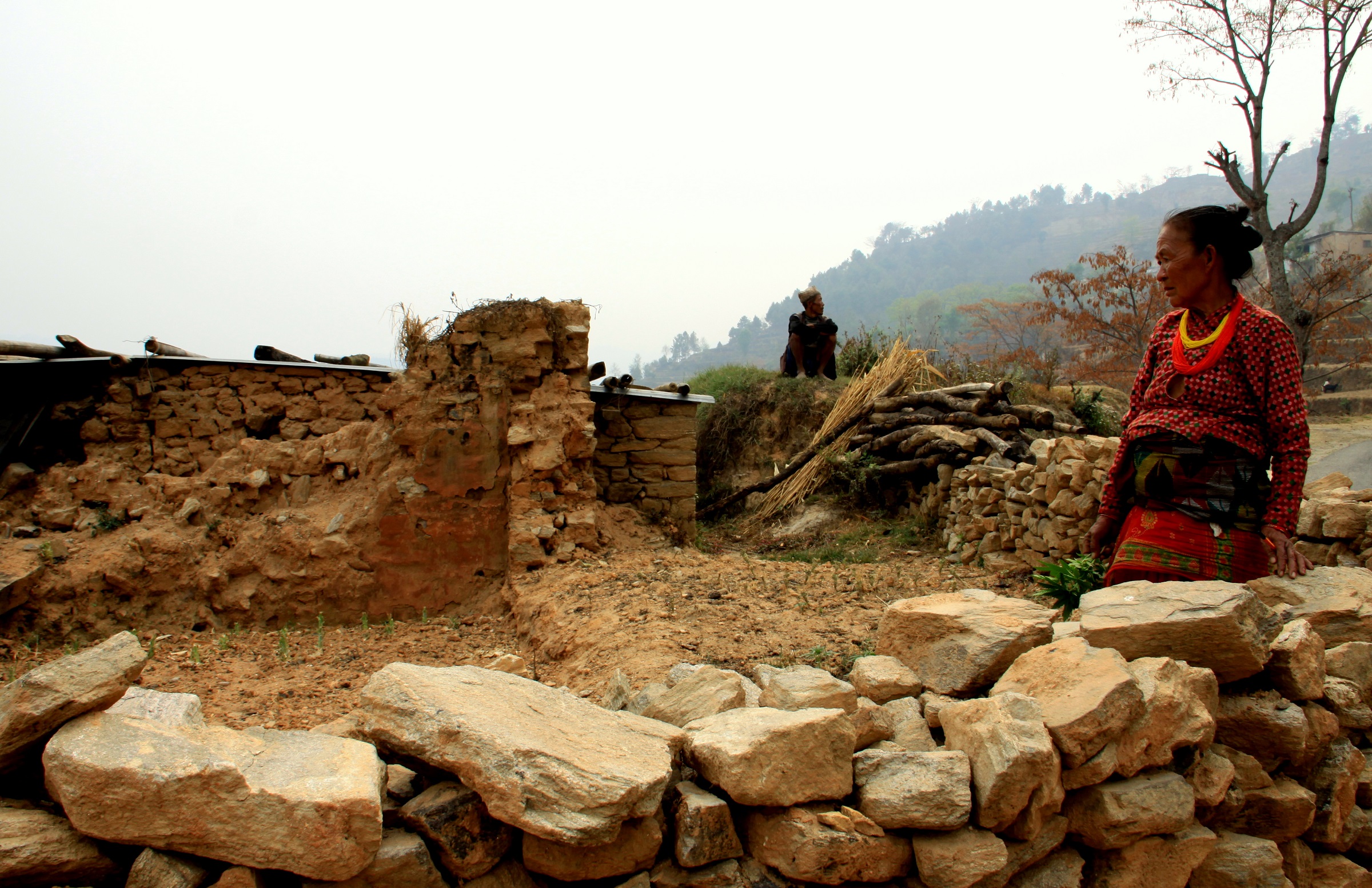 An elderly couple at the site of their house in Nanglebari, Nepal, that was destroyed by the 2015 earthquake. © 2016 Leesha Manju, Courtesy of Photoshare