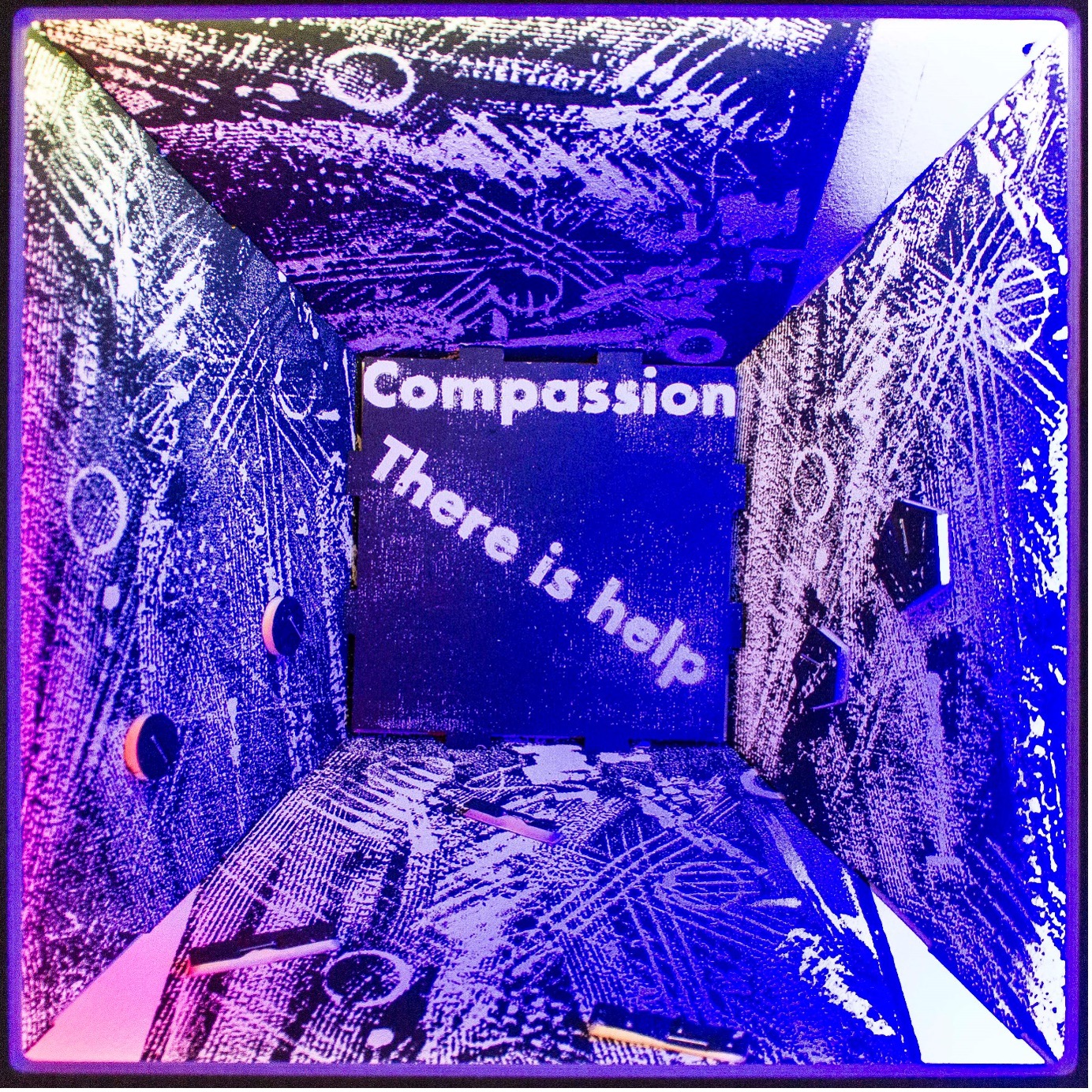 An art project with words including compassion and there is help