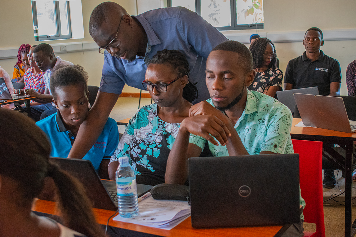 Staff guiding fellows through a training