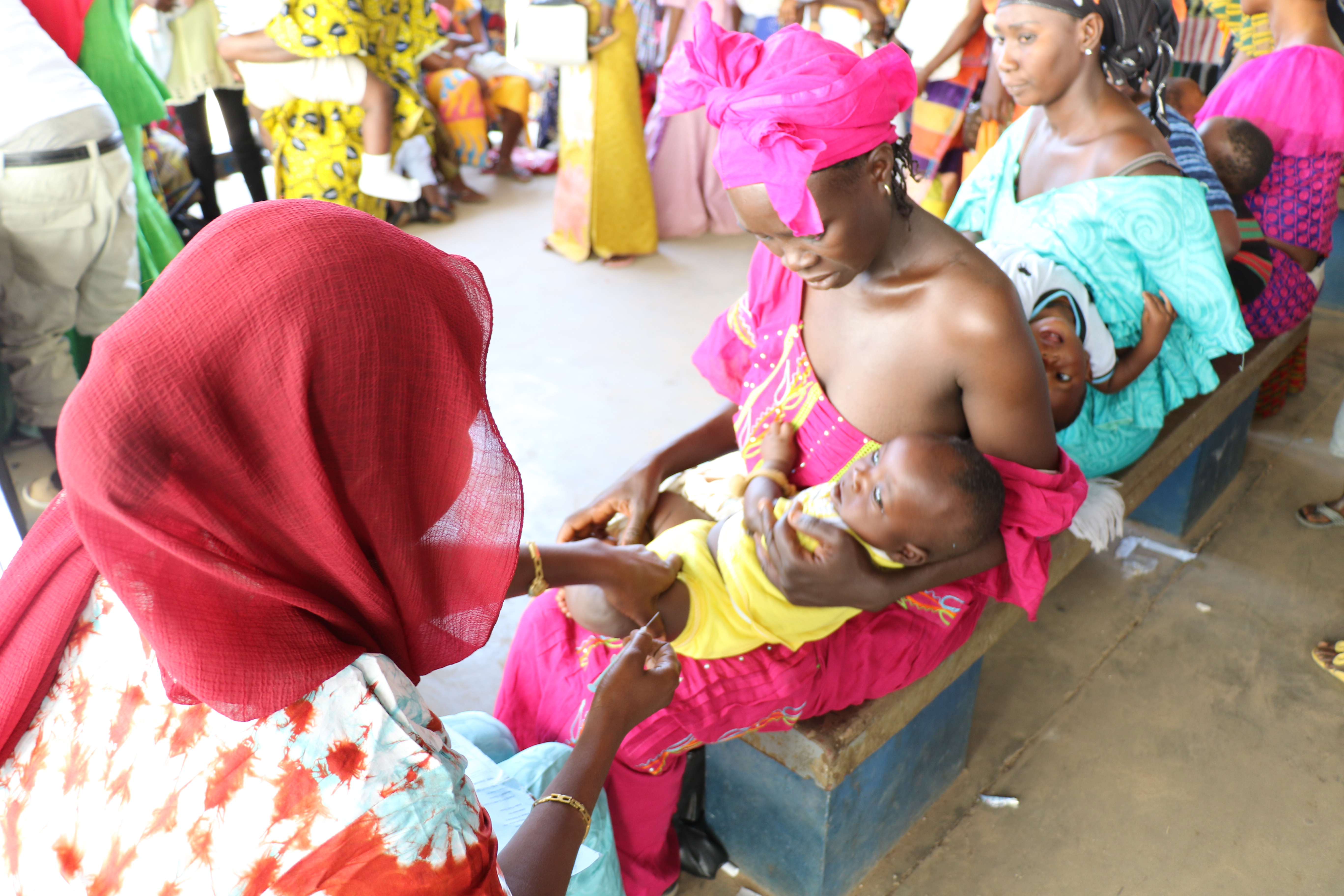 Baby being vaccinated in the community by MRC Unit The Gambia at LSHTM staff