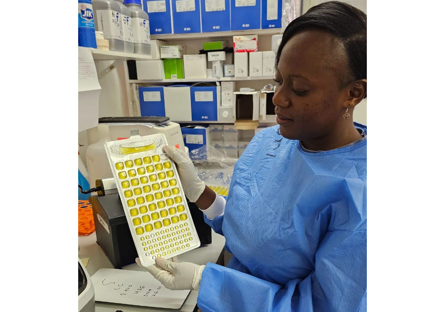 Jenala in the CISPOC lab learning how to use the IDEXX equipment to detect E coli in food samples