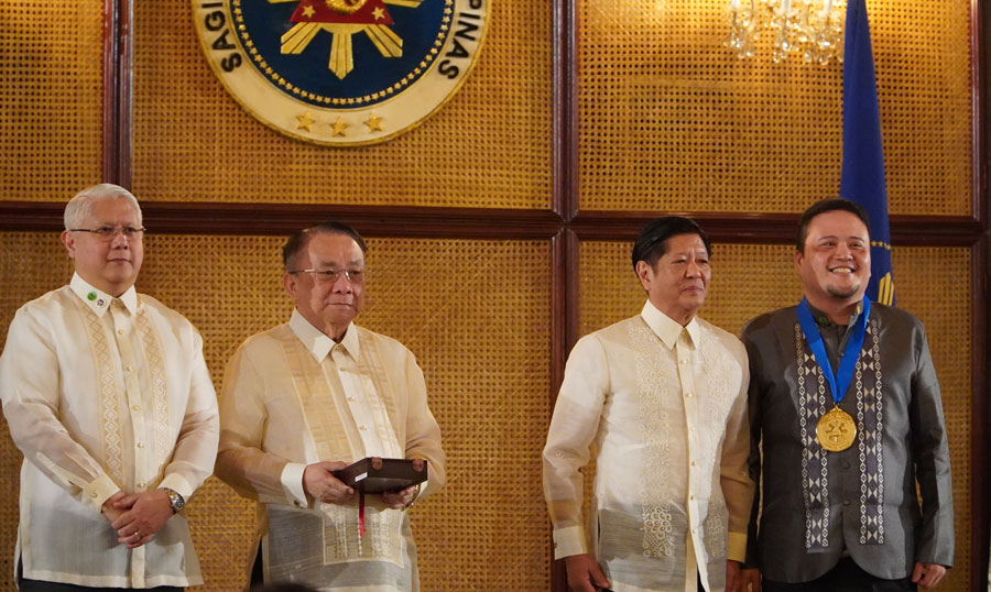 Melvin Sanicas wearing Pilipino Presidential Award