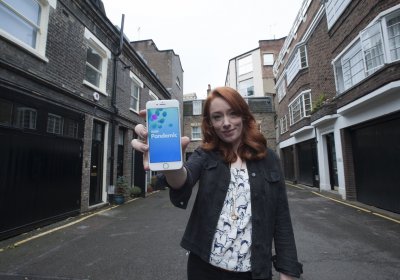 Hannah Fry holding a smartphone displaying the BBC Pandemic App. Credit: 360 Productions