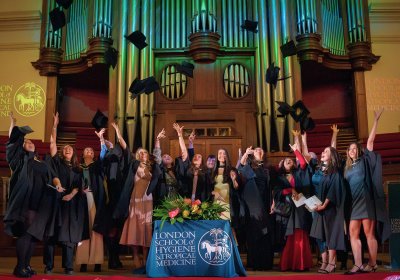 Graduates on stage celebrating.