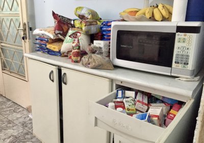 By Veronkia Reichenberger. In Brasilia, in a participant&#039;s house, we can see food on the counter and the medicine drawer open