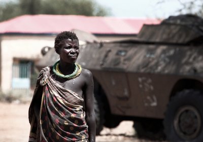 image of a woman standing in front of a military tank in south sudan