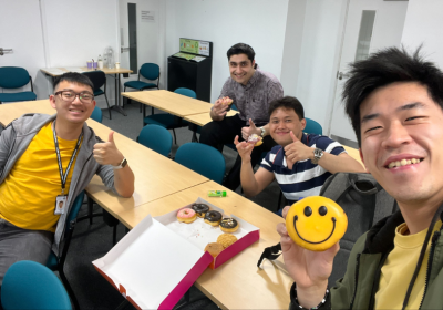 4 students in a LSHTM classroom taking a selfie