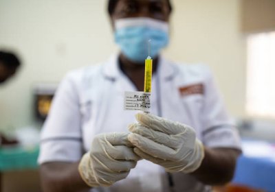 Nurse measuring a drug in a syringe. 