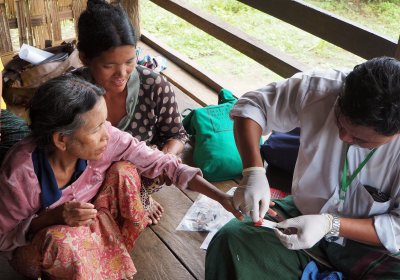 Woman getting tested for malaria in southeast asia