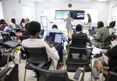 individuals participating in a training in a seminar room at MRCG