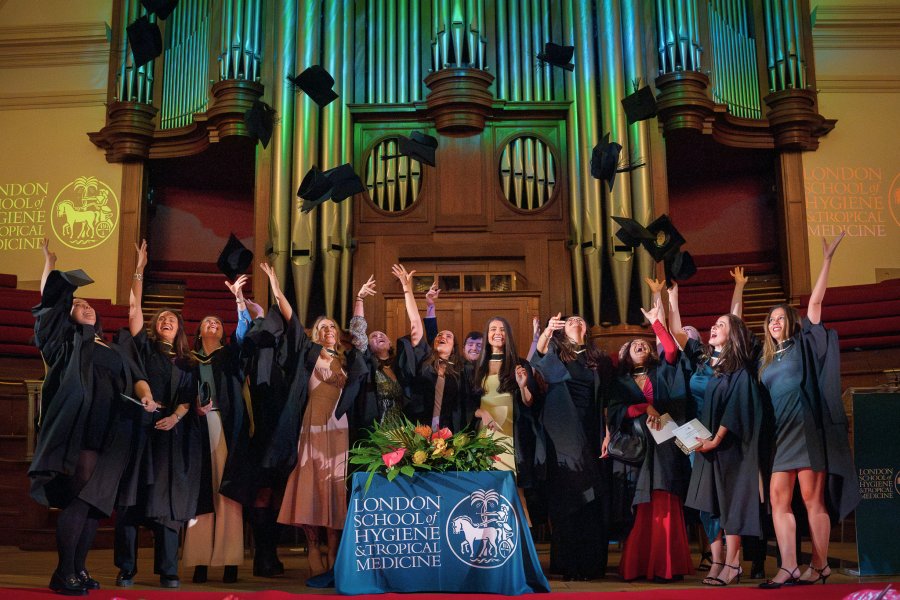 Graduates on stage celebrating.