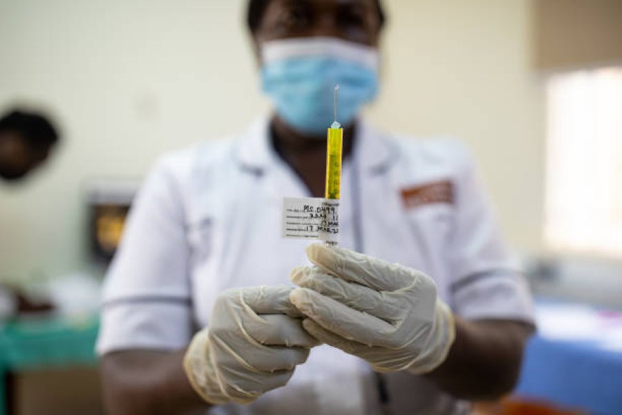Nurse measuring a drug in a syringe. 