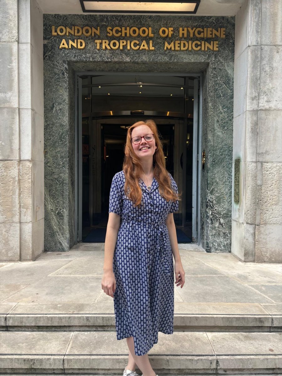 Sophie Moss standing in front of the entrance of LSHTM, Keppel Street