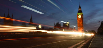 Photo of Big Ben at night with light trail over Westminster Bridge
