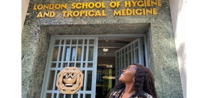 Omolayo Anjorin looking up at entrance marked &#039;London School of Hygiene and Tropical Medicine&#039;
