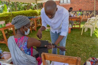 Allan Kalungi interacting with a research participant